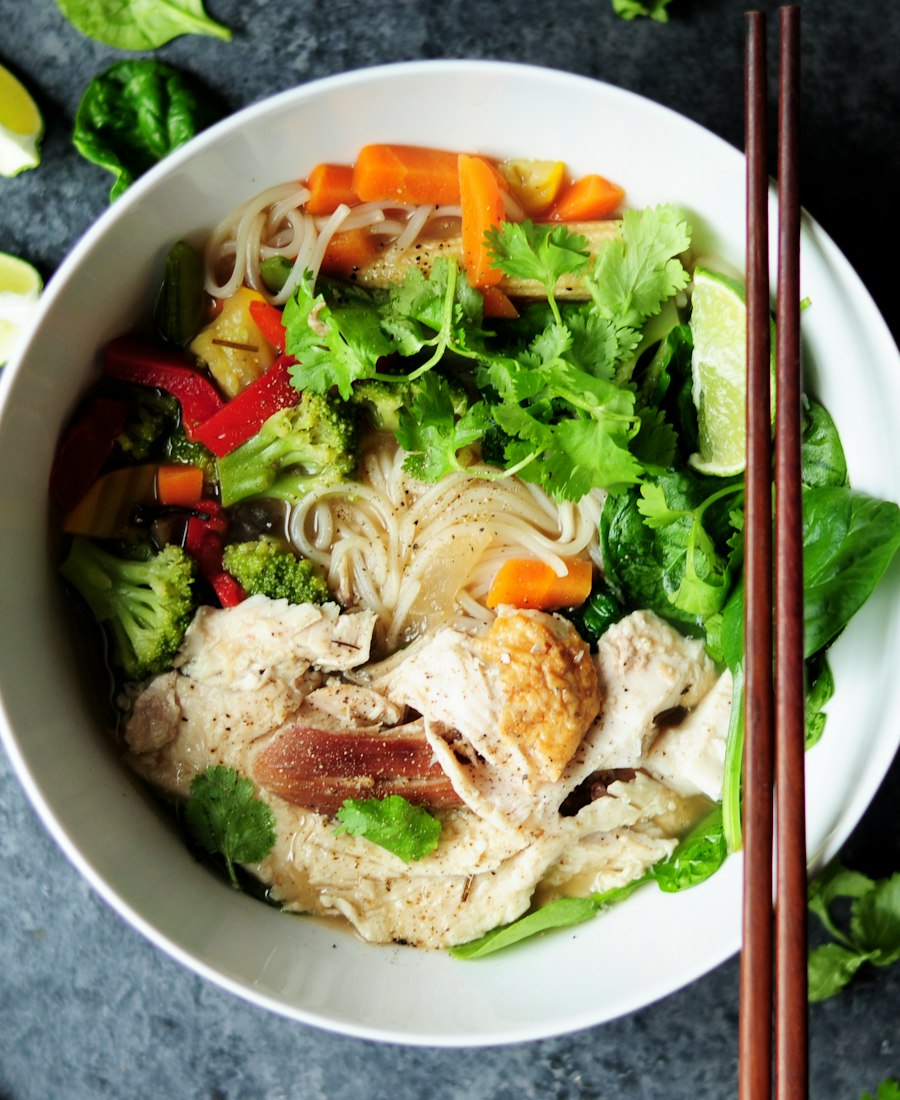 Fresh noodle bowl with vegetables and herbs